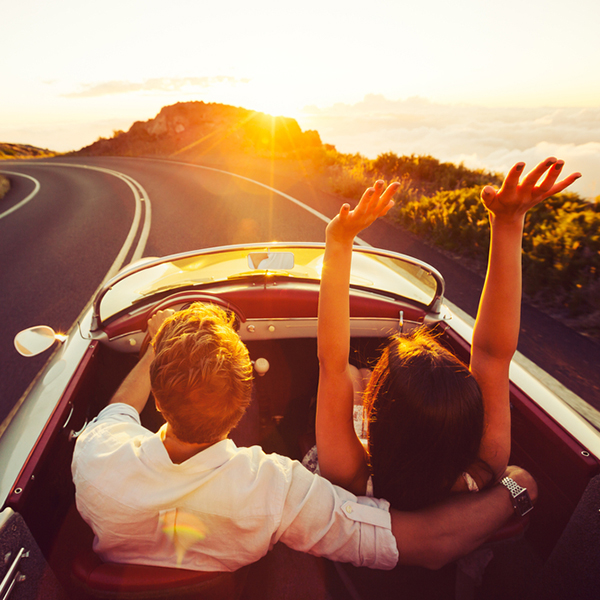 Happy,Couple,Driving,On,Country,Road,Into,The,Sunset,In vintage car